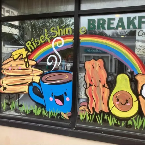 Hand-painted breakfast window mural with pancakes, coffee, bacon, and avocado