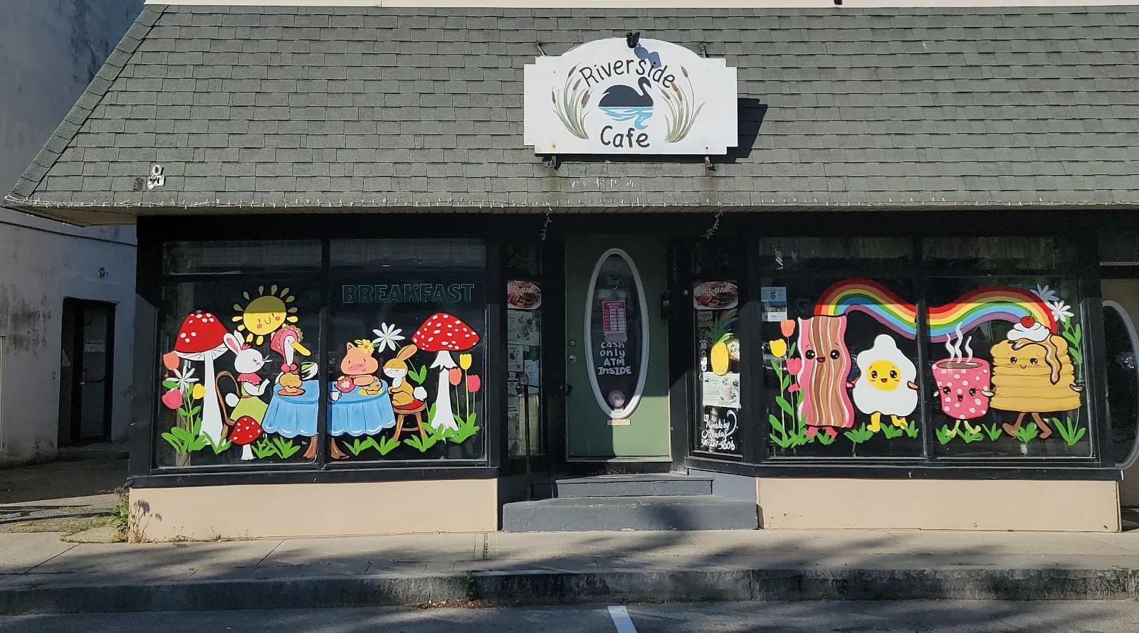 Riverside Cafe storefront on Main Street in Wareham, with painted breakfast murals in the windows